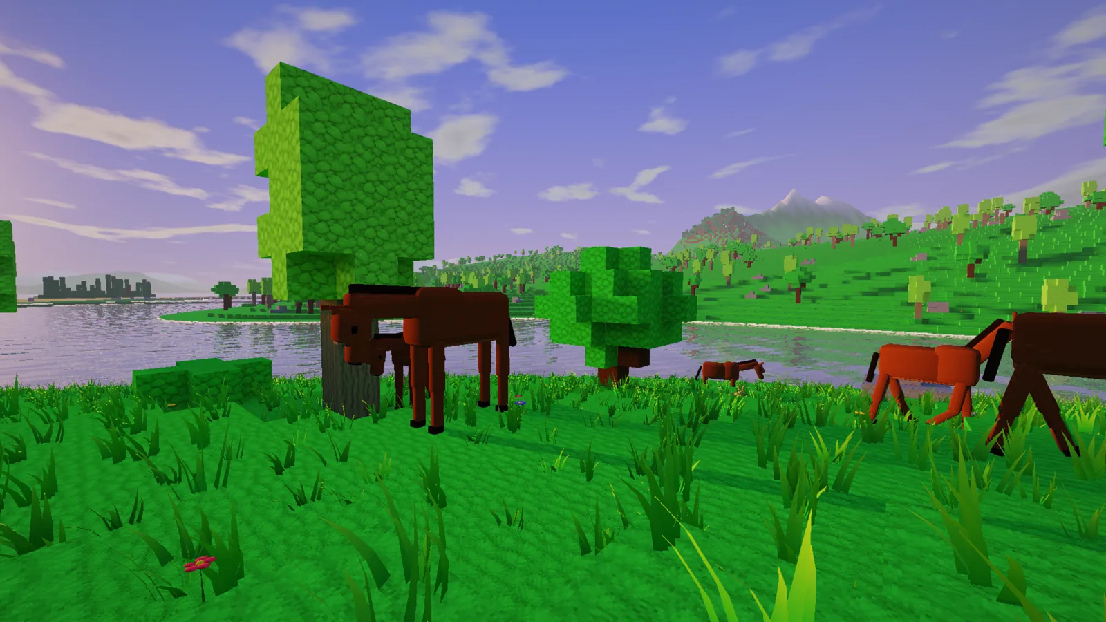 Animals in a meadow by a lake